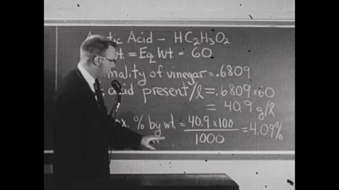 1950s: Man talking about the various chemical attributes of acetic acid. Man Stock Footage 241508996