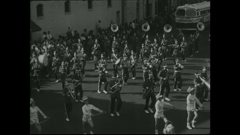 1950s:  Marching band. Parade float shaped like boat. Stock Footage 74761549
