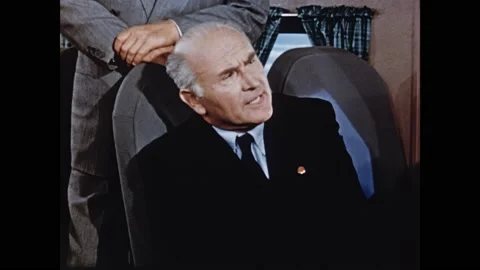 1950s: Men lean over seats and talk on plane. Stewardess brings drinks to men on Stock Footage 165426309