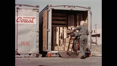 1950s: Men load boxes into the trailer of a shipping truck, man stacks and 스톡 동영상 211290500