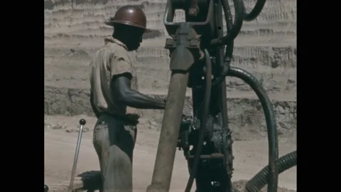1950s: Men operate large drills at mining site. Stock Footage 219816638