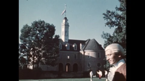 1950s: Men stand outside of Williamsburg Colonial capitol. Man in a wig looks at Stock Footage 291333419