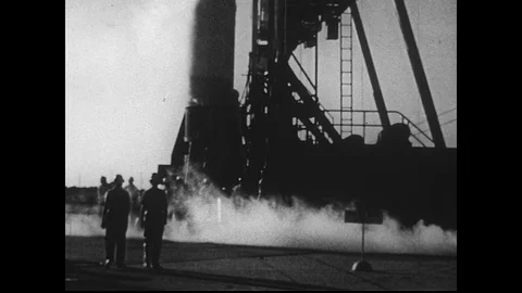 1950s: Men Walking Around the Base of Rocket Before Launch Stock Footage 74917110