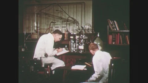 1950s: men work in chemisty laboratory. hand twists glassware and knobs on 스톡 동영상 76154683