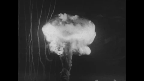 1950s: A mushroom cloud forms in the air after an atomic bomb goes off. Stock Footage 74428363
