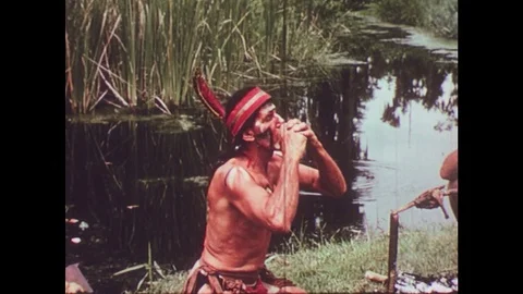 1950s: Native American man eats orange / Native Americans eat by fire. Stock Footage 74683582