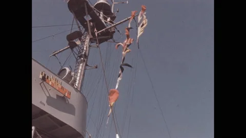 1950s: Nautical flags fly off the mast of a ship. Boy walks into llama pen, Stock Footage 138708640