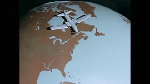 1950s: Note card over globe. Model plane sitting over North Eastern Canada. Vidéo 165356930