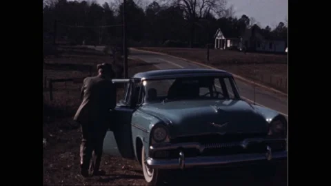 1950s: Passengers and driver gets back in car parked on shoulder of road and Vídeo Stock 164542805