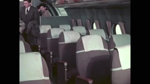 1950s: Passengers boarding plane, sitting in their seats. Stock Footage 219965150