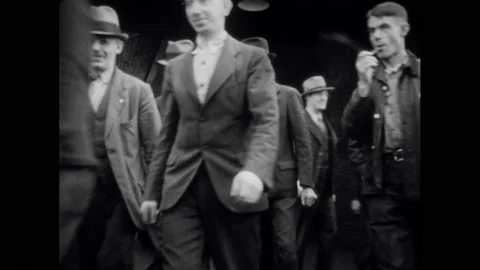 1950s: People walk down steps.  Workers leave factory.  Parking lot.  Factories Stock Footage 160572707