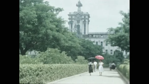 1950s: People walking on path through garden. University of Santo Tomas 動画素材 188532829