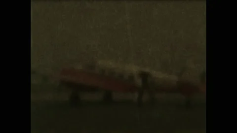 1950s: Pilot steps down from small plane and shakes hand on passenger on tarmac. Stock Footage 142920411