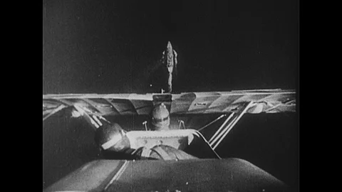 1950s: Pilots fly planes, drop bombs. Bomb explodes on battleship. Air Mail Stockbeeldmateriaal 91155718