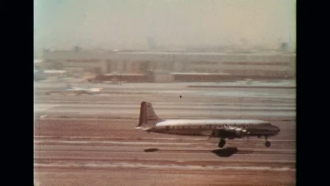 1950s: A plane arrives at an airport carrying passengers. Stock Footage