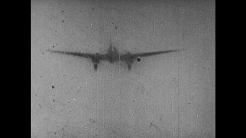 1950s: Planes fly through sky, men parachute out of planes. Planes lined up on Stock Footage 91155751