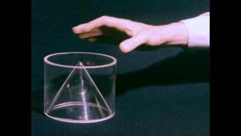 1950s: Plastic cone on table, hand places cylinder over cone, takes away cone, Stock Footage 240676675
