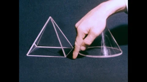 1950s: Plastic cones on table, hand picks up cones, places box over cone. Stock Footage 240676699