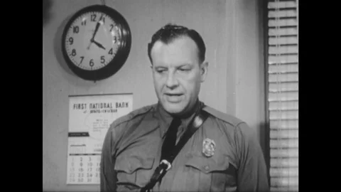 1950s: policeman talks in station. Boy holds head in hands. Man talks to Stock Footage