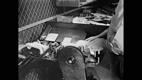 1950s: Postal worker sends letters through canceling machine.  Man takes stacks Stock Footage 157457351