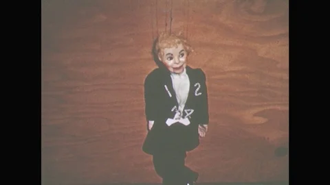 1950s: Puppet stands against wall, talks. Boy walks over to radio, numbers Stock Footage 82047952
