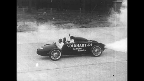 1950s: A race car is photographed as it speeds and leaves the audience in its Stock Footage