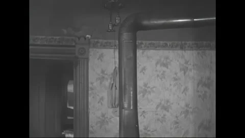 1950s: Rustic metal duct pipe extending outward from a cozy wood-burning stove, Stock Footage 158819670