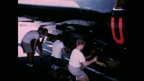 1950s: Several men setup recording equipment on jet plane. Men service Air Force Stockbeeldmateriaal 159389573