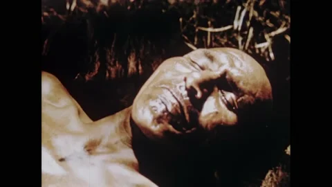 1950s: Sick man inside of teepee. Medicine man waves eagle feather over sick Stock Footage 164976099