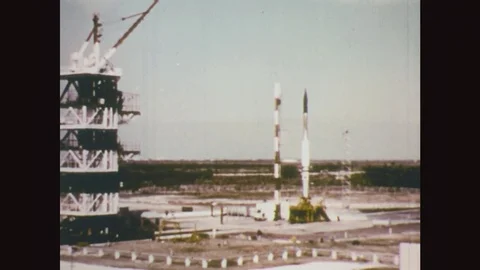 1950s: Smoking rocket launch at shore explodes into cloud. Two men adjust 스톡 동영상 77217702