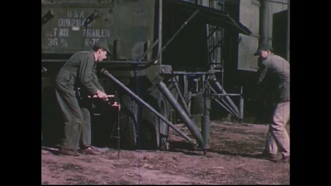 1950s: Soldiers position military equipment / Scientist climbs on radar truck / Stock Footage