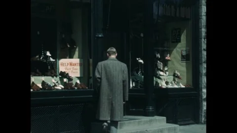 1950s: A storefront window displays a help wanted sign alongside an array of Stock Footage 280764429