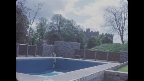 1950s: Swimming pool with castle in back... | Stock Video | Pond5