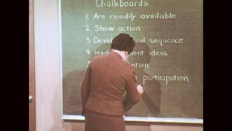 1950s: Teacher adds "Are Adaptable" to chalkboard list. Teacher writes musical Video stock 78493403