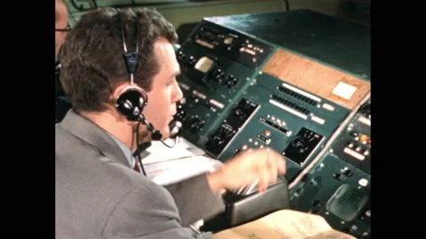 1950s: Television studio.  Men work in control room.  Man speaks into headset. Stock Footage 171464370