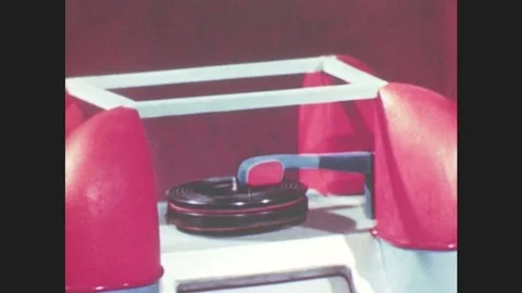 1950s: Toy record spins on model jukebox. Woman puppet lays over couch, talks on Stock Footage 79474918
