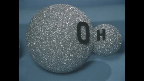 1950s: two linked gray styrofoam balls labeled O and H Stock Footage 279488487