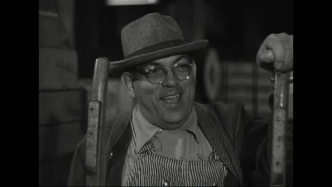 1950s - Two workers unload crates of produce from an impatient trucker. Stock Footage