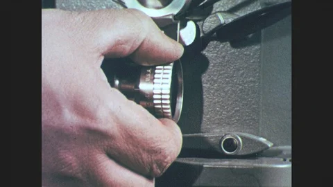 1950s: UNITED STATES: button on projector screen. Focus on projector screen. Stock Footage 86681424