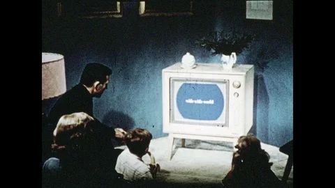 1950s: UNITED STATES: family watches television monitor at home. Taj Mahal Stock Footage