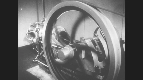 1950s: United States: Fly Wheel Turns On Machine. Close Up Of Running Engine. Stock Footage