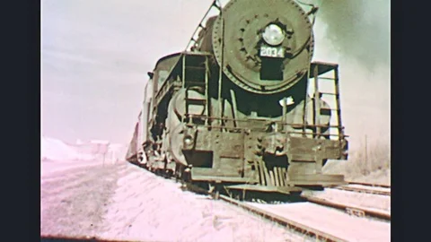 1950s: UNITED STATES: front view of slow moving steam train on tracks. Side view Stock Footage