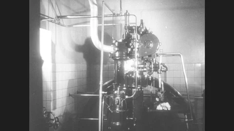 1950s: United States: Man Climbs Up Steps To Look At Machine. Compression Engine Stock Footage 80688564