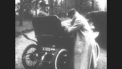 1950s: United States: Man Starts Early Motor Car. Motor Car With Engine. Car Stock Footage