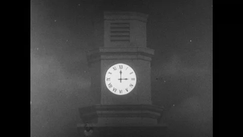 1950s: View of clock tower / Dissolve, baby in crib, hand pulls up blanket  / Vídeo Stock 74930365