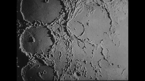 1950s: View of surface of moon / Photograph of moon / Rocket launching. Stock Footage