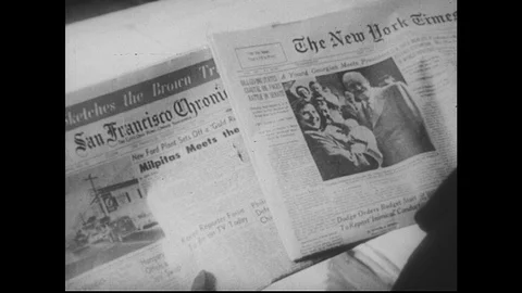 1950s: View of two different newspapers / Man and boy reading papers in home / Stock Footage 74475334