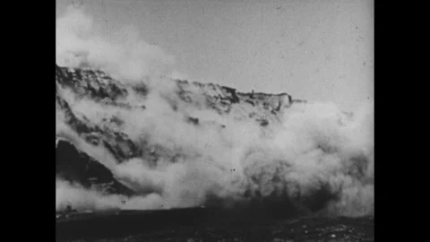 1950s: Wall in a  open mine explodes. Excavator loads coal into a truck. Men Stock Footage 251001394