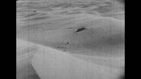 1950s: Wind blows over sand through a desert. Stock Footage
