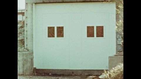1950s: Windows on outside wall of testing tunnel, wall blows off, bright fire Stock Footage 92587655